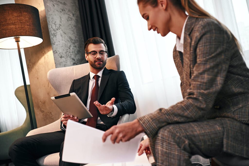 Director de hotel liderando una reunión con su equipo de trabajo para optimizar la gestión de recursos humanos.